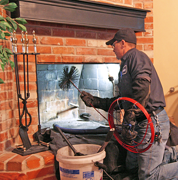Technician providing chimney sweep services in League City, TX